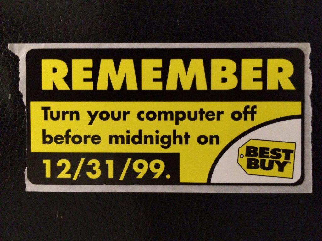 An old Best Buy tag that says "REMEMBER: Turn your computer off before midnight on 12/31/99."